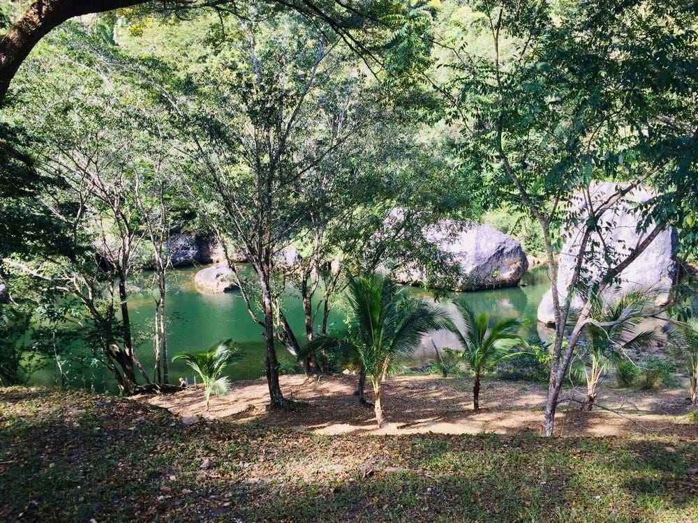 The river and surrounding rainforest on the grounds of Black Rock Lodge, one of the best Belize resorts for a family vacation.