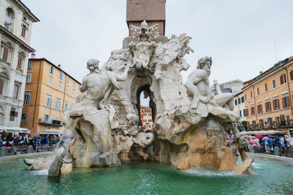 A close up of the base of the obelisk in the highly-artistic Fontana dei Quattro Fiumi in Rome.