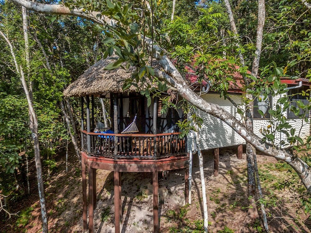 A stilted cabana area at Table Rock Jungle Lodge, one of the best Belize resorts for a family vacation.