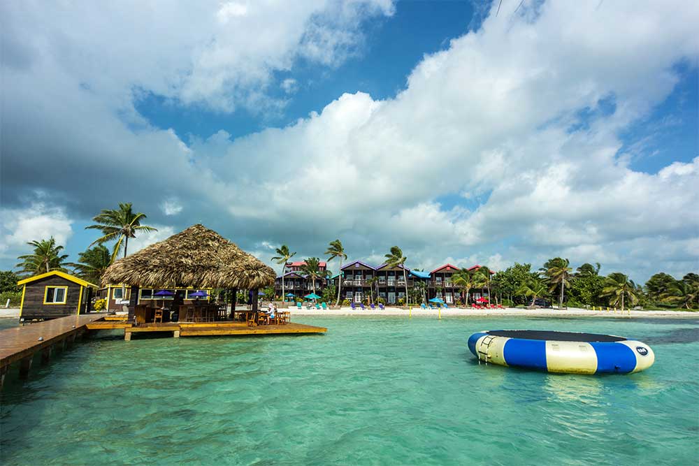 A large inflatable rests on the ocean near the beach at X’Tan Ha Resort, one of the best Belize resorts for a family vacation.