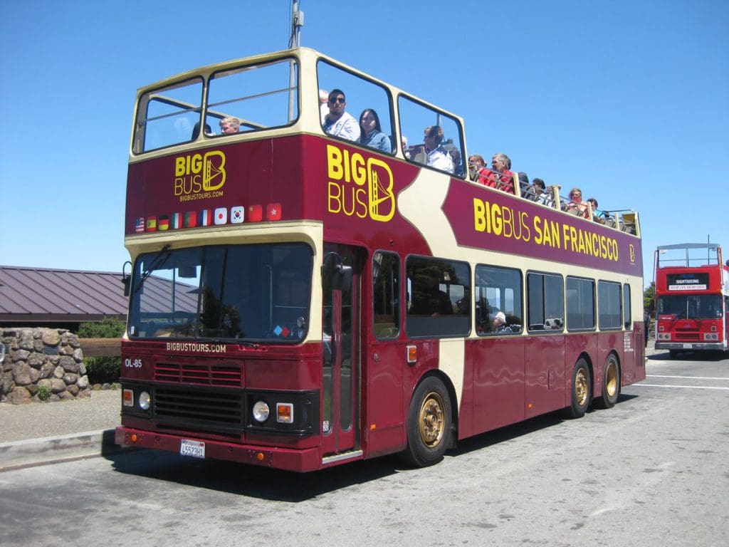 A hop-on, hop-off bus filled with people in San Francisco.