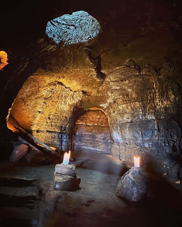 Two lights illuminate the inside of Hella Cave.