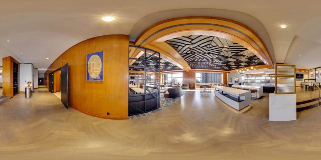 The large indoor lobby, in hues of golden brown, at Le Centre Sheraton Montreal Hotel.