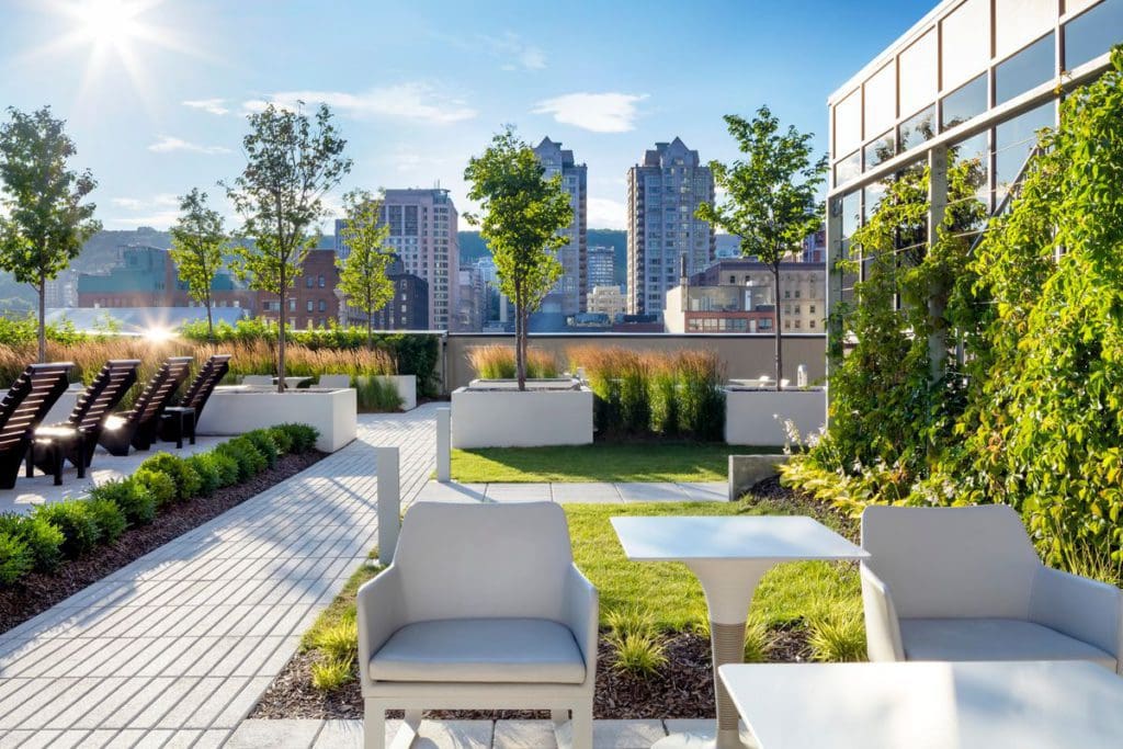The large outdoor terrace, trimmed with shrubbery and a great skyline view, at Le Centre Sheraton Montreal Hotel.