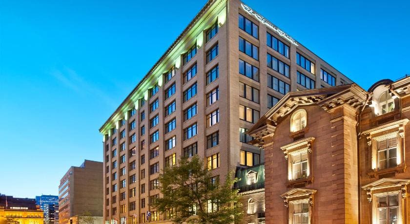 The large, stone exterior of Le Square Phillips Hôtel & Suites.