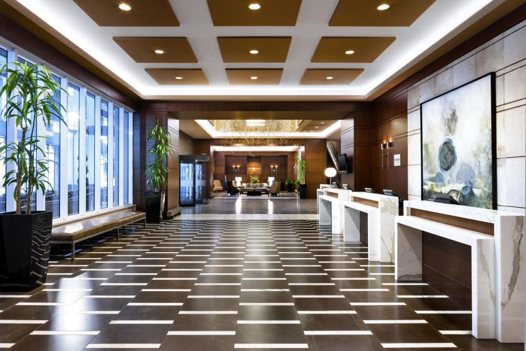 The welcoming indoor lobby to Le Westin Montreal, featuring hues of brown and gold.