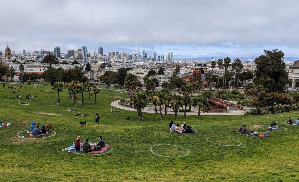 Mission Dolores Park in 2020 with social-distancing circles painted on the grass to help small family groups stay safely away from each other.