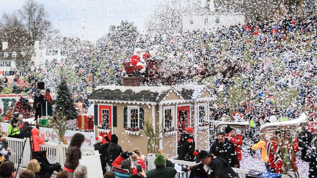 Santa rides atop a ginger bread house during the America's Hometown Thanksgiving Celebration parade in Plymouth, one of the best Thanksgiving destinations in the United States for families.