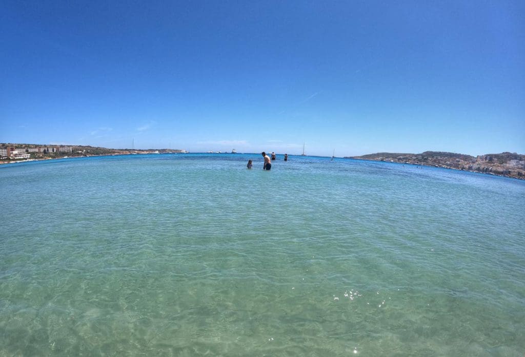 A dad and his daughter play off-shore from Mellieha Beach.