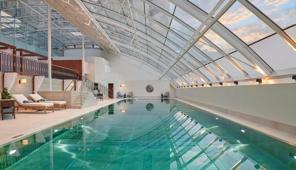 The indoor pool with an overhead atrium-style window at The Carlton Tower Jumeirah.