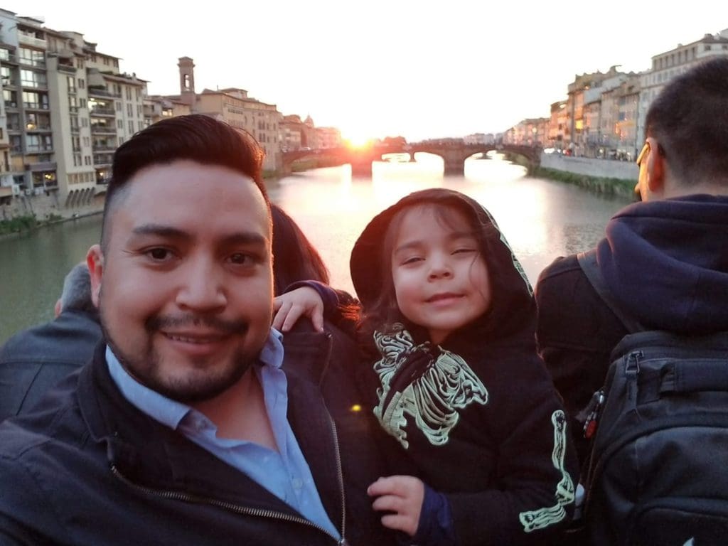 A dad and his child enjoy a river cruise on a barchetto.