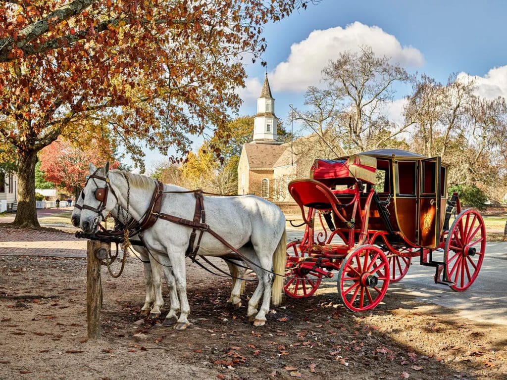 A horse-drawn carriage stands empty in a fall scene in Williamsburg, Virginia, one of the best Labor Day Weekend getaways near DC for families.