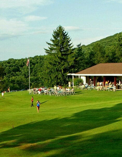 Kids playing in the large green field at Capon Springs Resort and Spa.