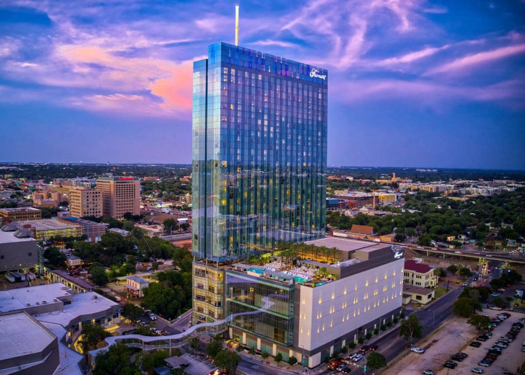 An aerial view of Fairmont Austin at dusk, with the surrounding Austin skyline.
