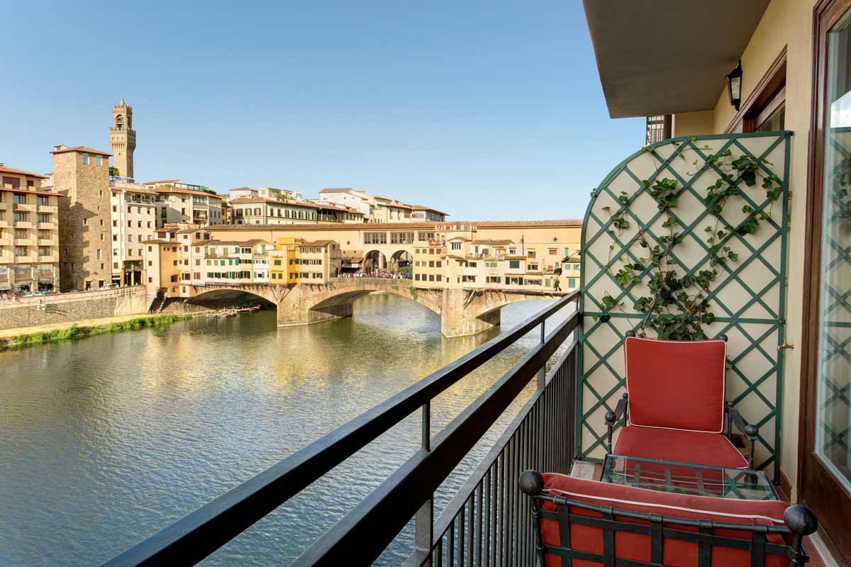 A balcony at Hotel Lungarno, overlooking the river and one of the iconic bridges of Florence.