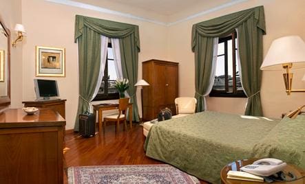 Inside one of the simple rooms at Hotel Pierre, with a lovely bed and wardrobe. 