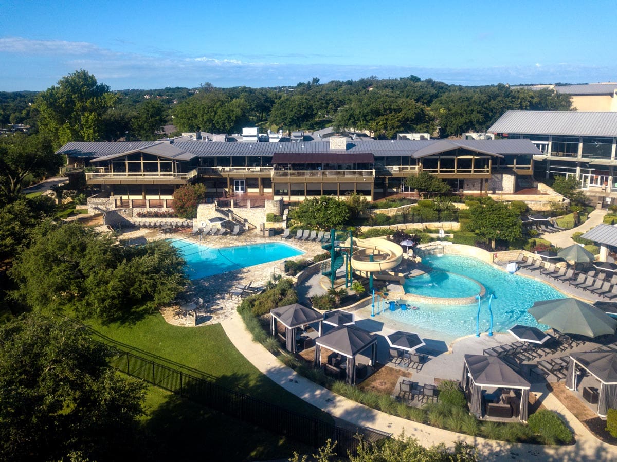 An aerial view of the pool and surrounding resort buildings at Lakeway Resort and Spa.