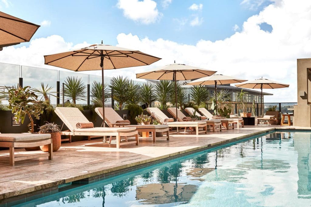 The charming outdoor pool, with pool deck loungers flanking one side, at Austin Proper Hotel.