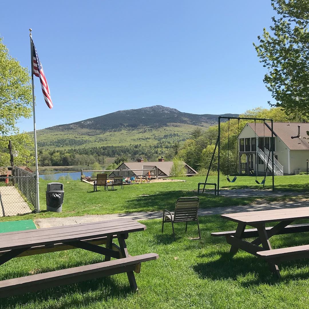 A small picnic table and playground area awaits guests at The Inn at East Hill Farm, one of the best all-inclusive hotels in the United States for families.