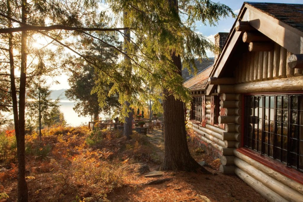 The outside of the Main Lodge, looking through the woods toward a lake at The Point.