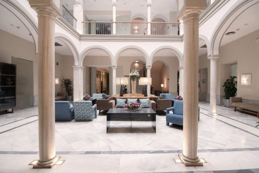 Inside the modern meets traditional lobby of The Petit Palace Marqués Santa Ana Hotel.