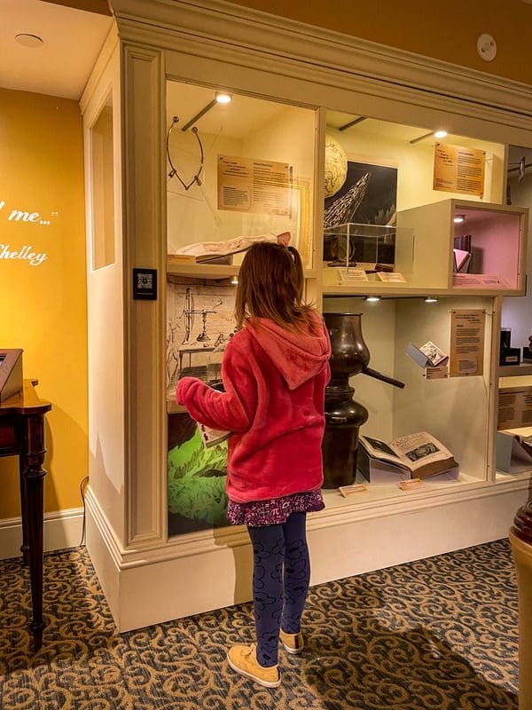 A young girl explore an exhibit on Mary Shelley at the Bakken Museum, one of the best places to explore in the Twin Cities with kids.