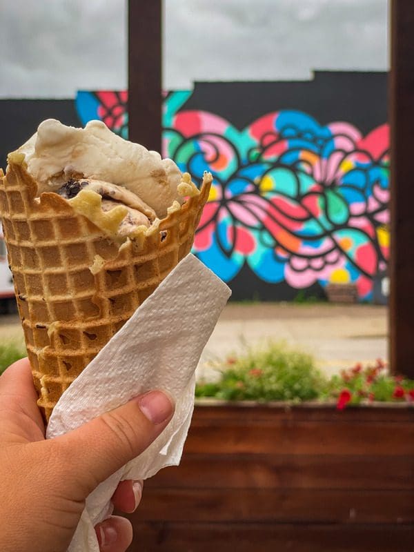 A hand holds out an ice cream cone at Ramone's in Eau Claire.