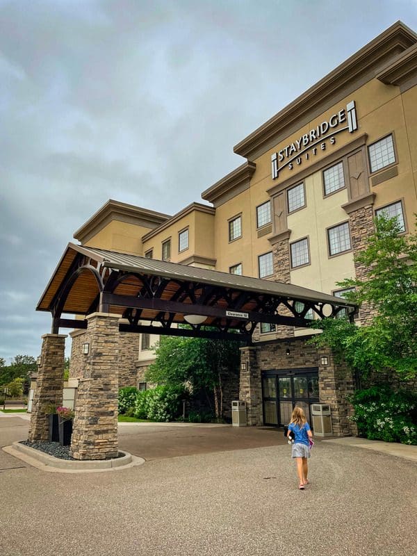 A young girl walks toward the entrance tot he Staybridge Suites in Eau Claire.