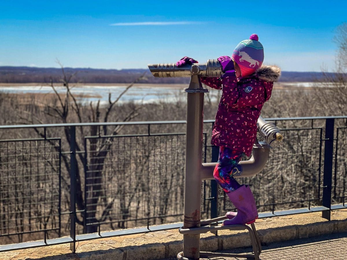 A young girl looks through a view finder at the Minnesota Valley National Wildlife Refuge in Bloomington.