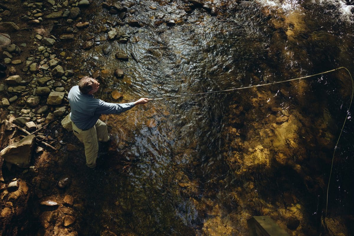 A man casts a line, while fishing at Blackberry Farm.