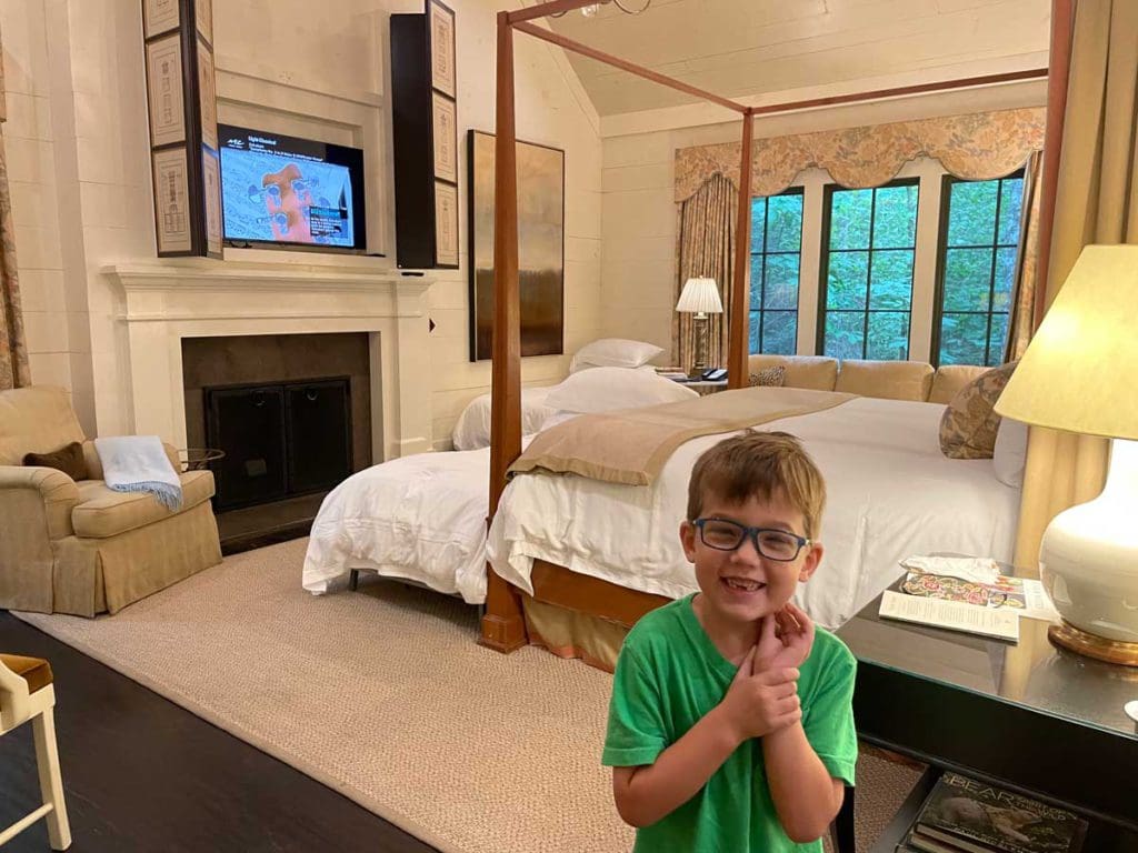 A young boy stands in a room at Blackberry Farm.