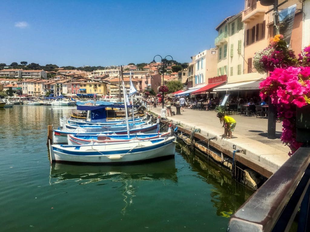 Boats sit along a oceanside sidewalk in Cassis.