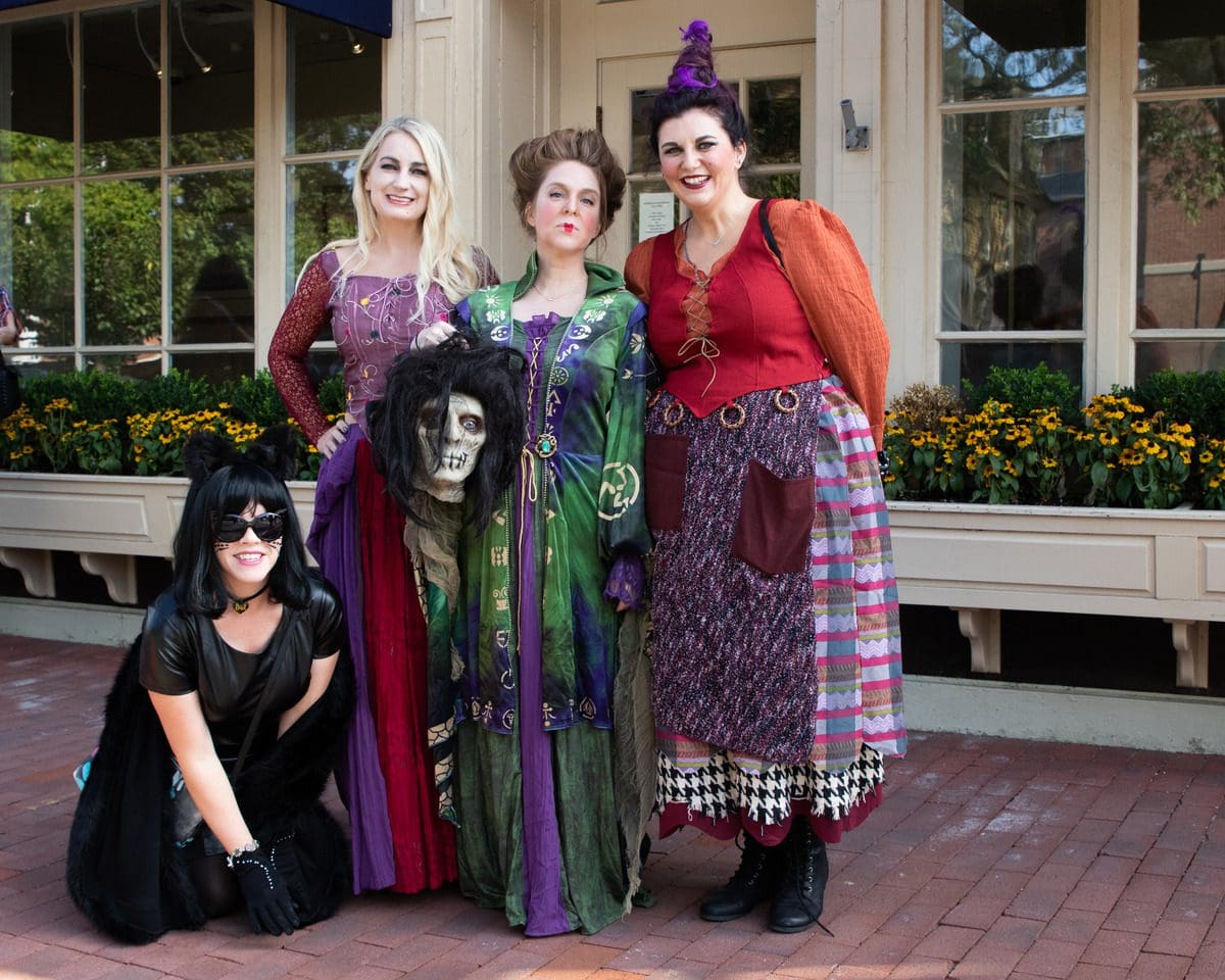 A group of people are dressed like characters from the movie Hocus Pocus, while visit Salem in the fall.