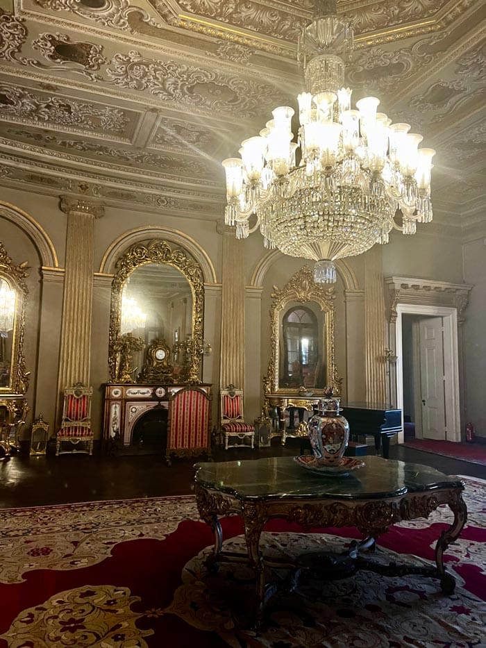 An interior room at the Dolmabahçe Palace, featuring a large table and grand chandelier.