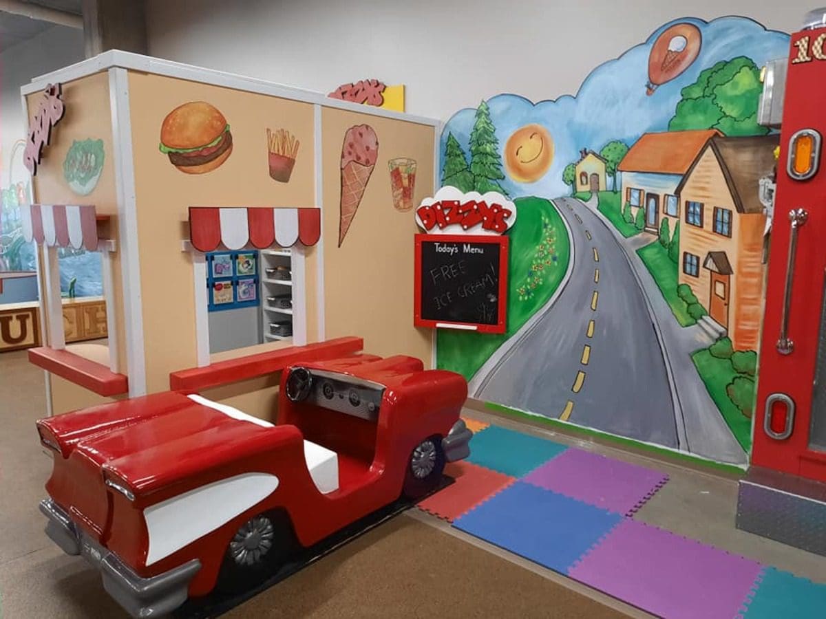 One of the temporary exhibits at Play Space, part of the Children’s Museum of Eau Claire, featuring a fun car and map.