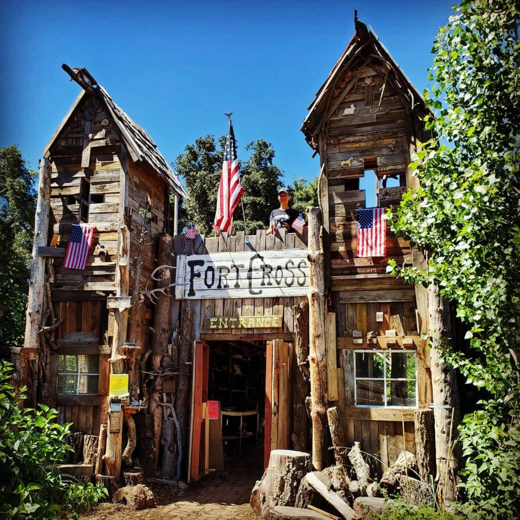 A young boy stands atop a fort at Fort Cross Adventures, one of the best places to visit in Julian with kids.