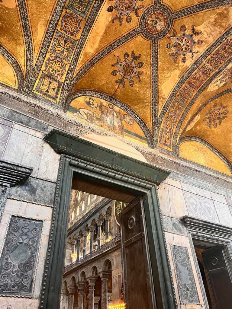 An architectural image of the arches and Islamic paintings inside Hagia Sophia in Istanbul, one of the best international destinations for teens interested in history.