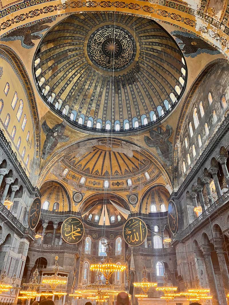 Inside Hagia Sophia, featuring a large and highly-decorated interior.