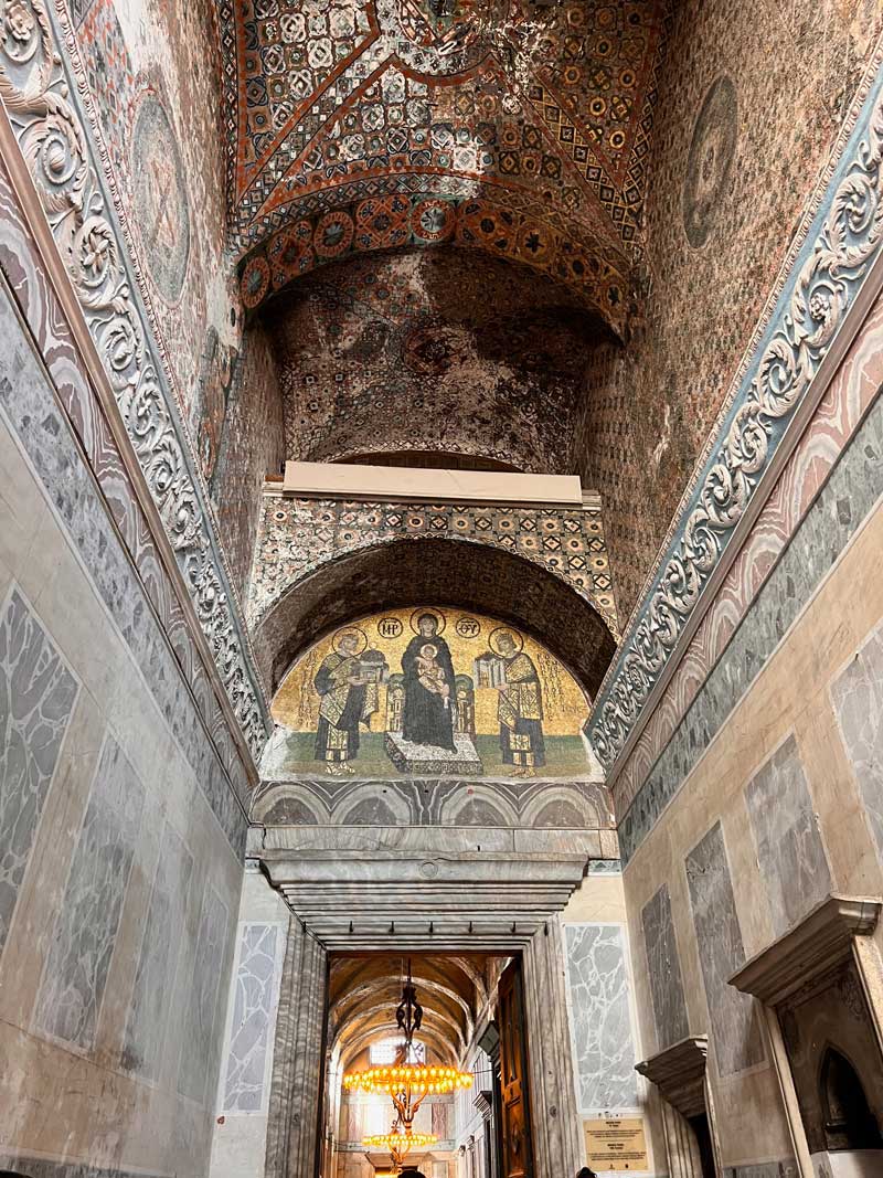 A hallway inside Hagia Sophia, ornately decorated and painted.