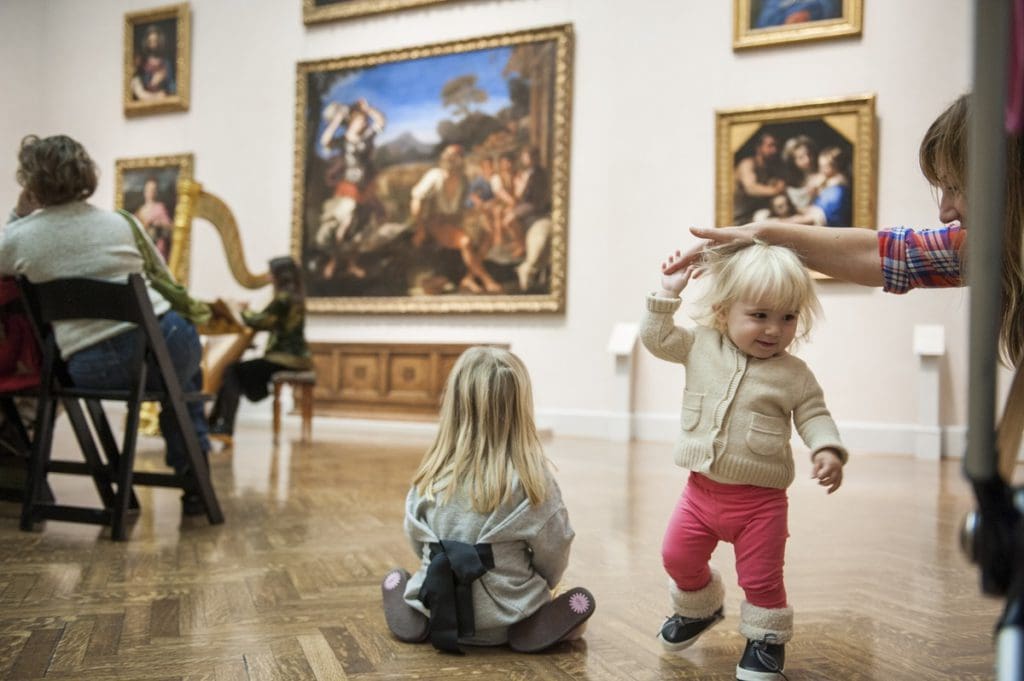 A family with young kids enjoy an art exhibit at Minneapolis Institute of Art.