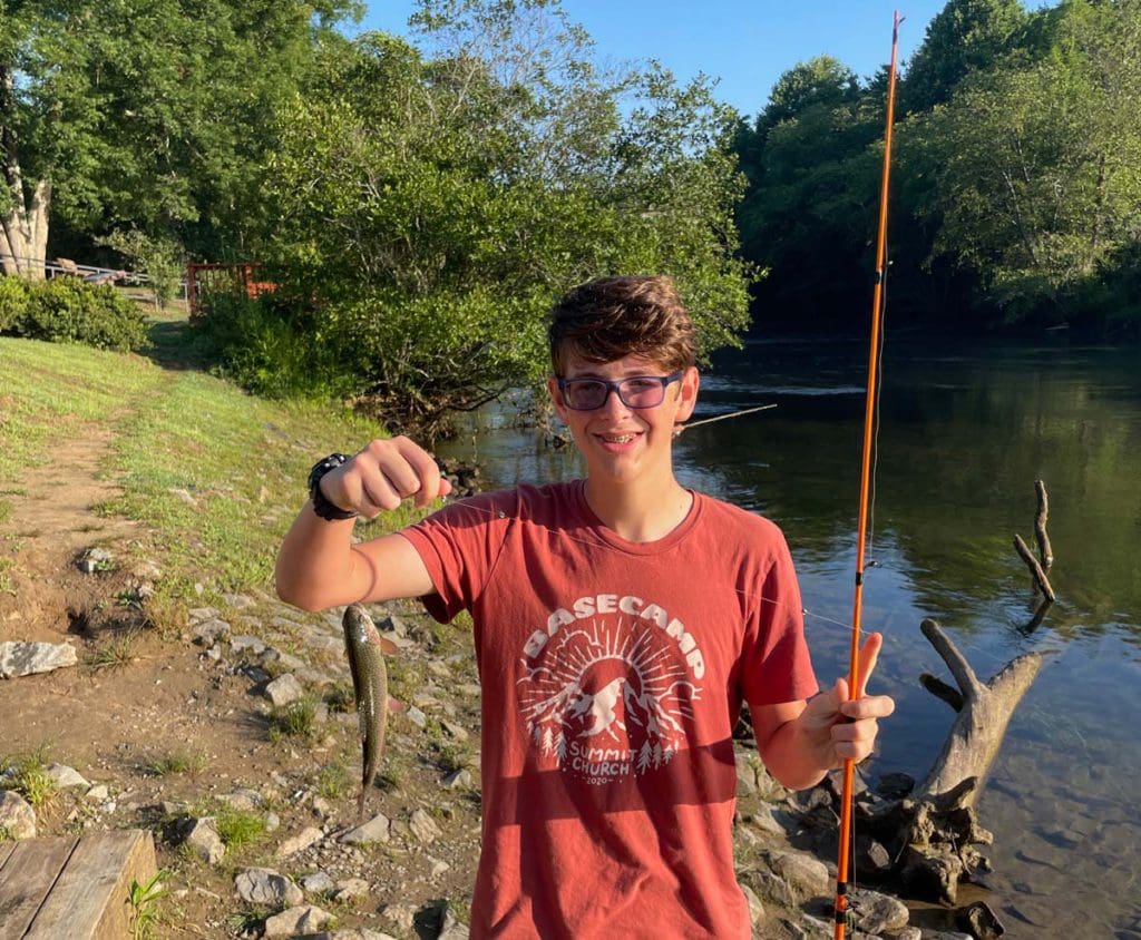 A teenager holds up a fish caught near Tammen Park.