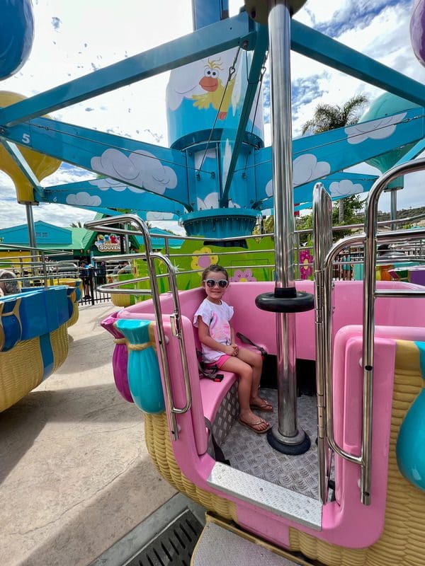 A young girl rides on one of the thrilling rides at Sesame Place San Diego.