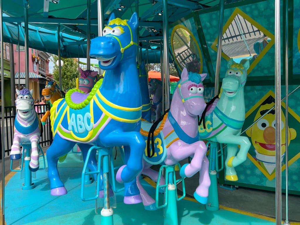 A carousel of Sesame Street-themed horses at Sesame Place San Diego.