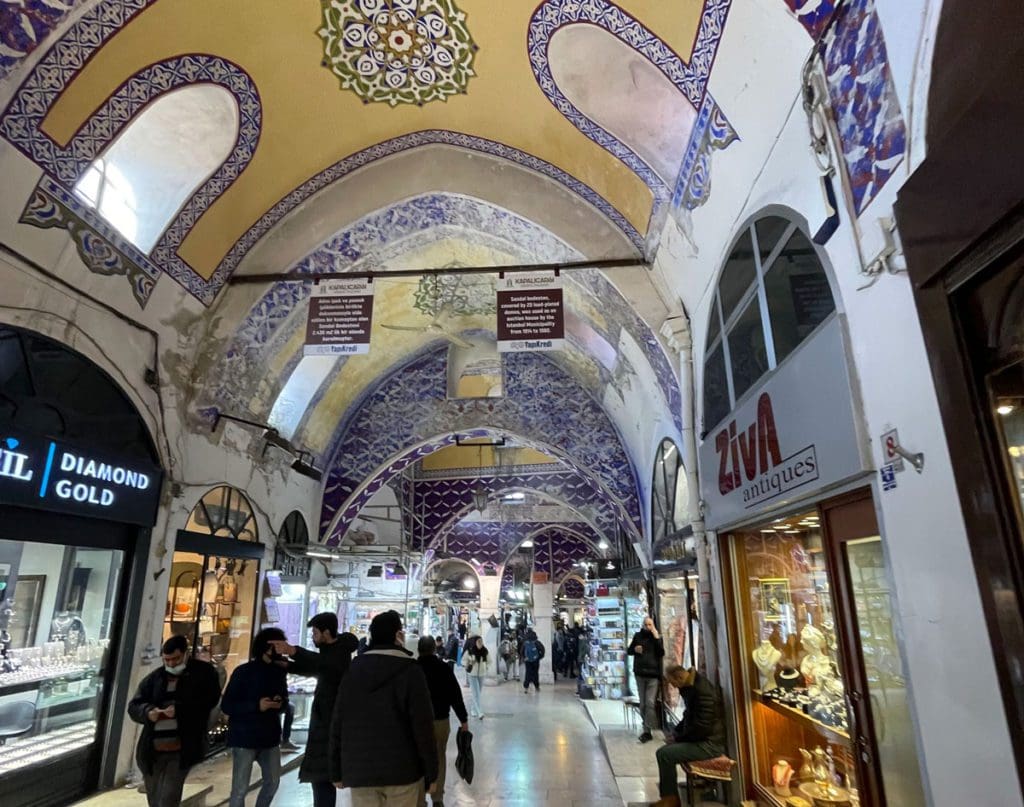 Inside the Grand Bazaar, people meandering about shopping, one of the best things to do on a family vacation to Istanbul.