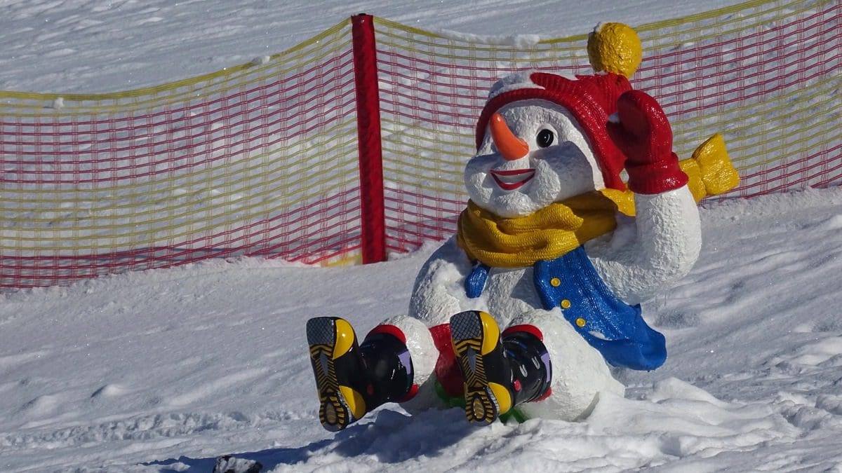 A snowman mascot toboggans at Snow Space Salzburg.