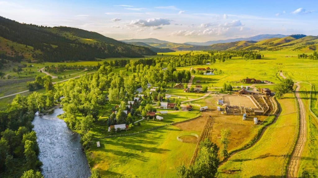 An arial view of the sprawling property of The Ranch at Rock Creek, lush green during the summer.