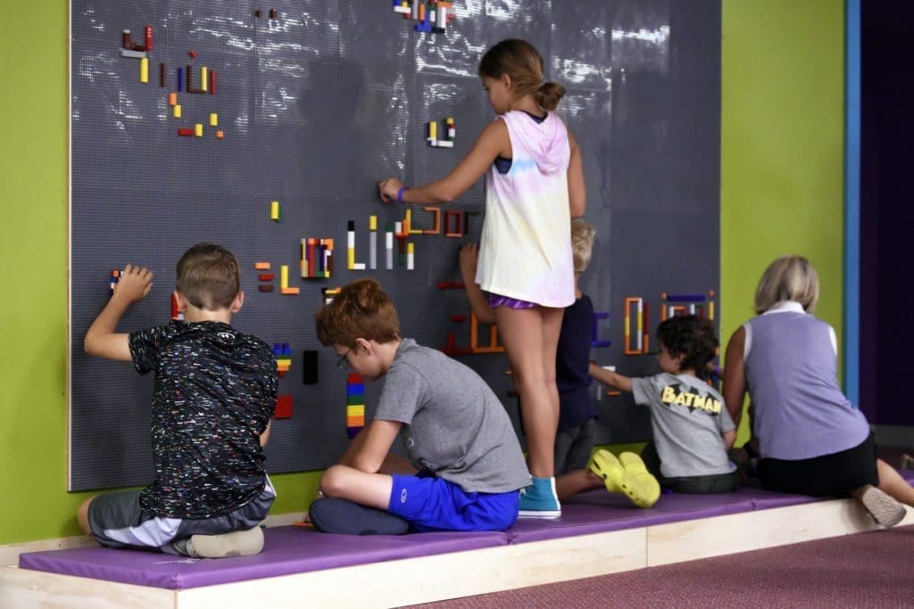 Kids play at a hands-on exhibit with legos and chalk at The Works Museum.