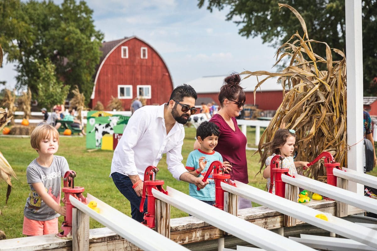 A family plays at an apple shoot area at Ferguson's Orchard on a fall day.