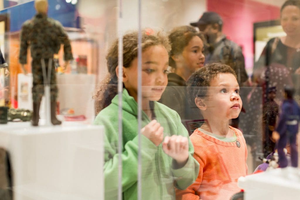 Two kids look into a museum case at the Minnesota History Center.