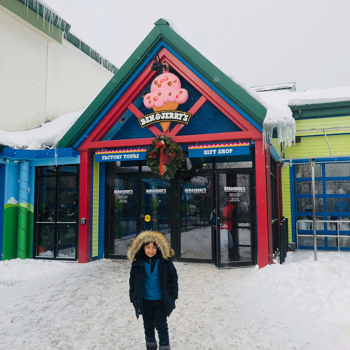 A young boy stands outside the entrance to Ben & Jerry’s Ice Cream Factory.